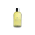 Gelbe Flasche Cardamom & Cedarwood Bath & Shower Gel mit silbernem Deckel auf weißem Hintergrund
