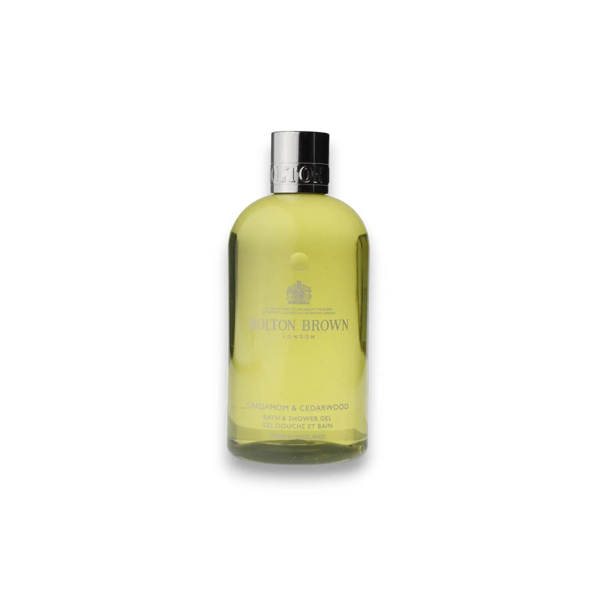 Gelbe Flasche Cardamom & Cedarwood Duschgel mit silbernem Deckel auf weißem Hintergrund