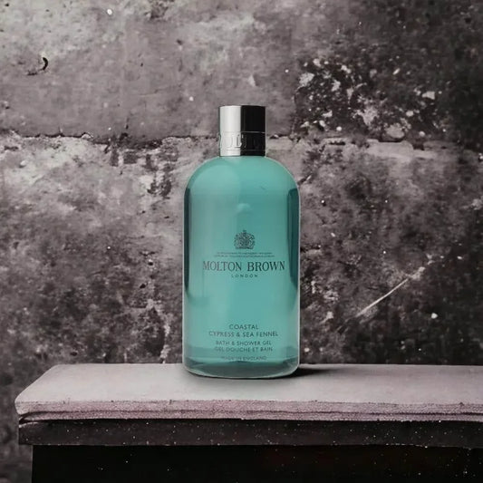 Molton Brown Coastal Cypress & Sea Fennel Duschgel Flasche vor Steinwand