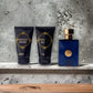 Dylan Blue Pour Homme Duftset mit Eau de Toilette, Duschgel und Aftershave, vor Betonwand