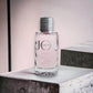 JOY Eau de Parfum Flakon mit rosafarbenem Duft auf hellem Podest, modernes Design