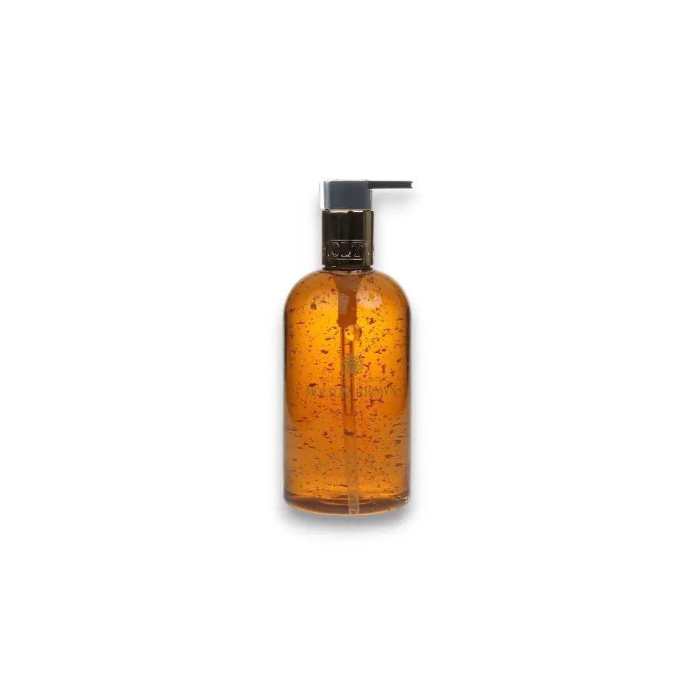 Luxuriöse goldene Handseife mit goldenen Partikeln in transparenter Pumpflasche