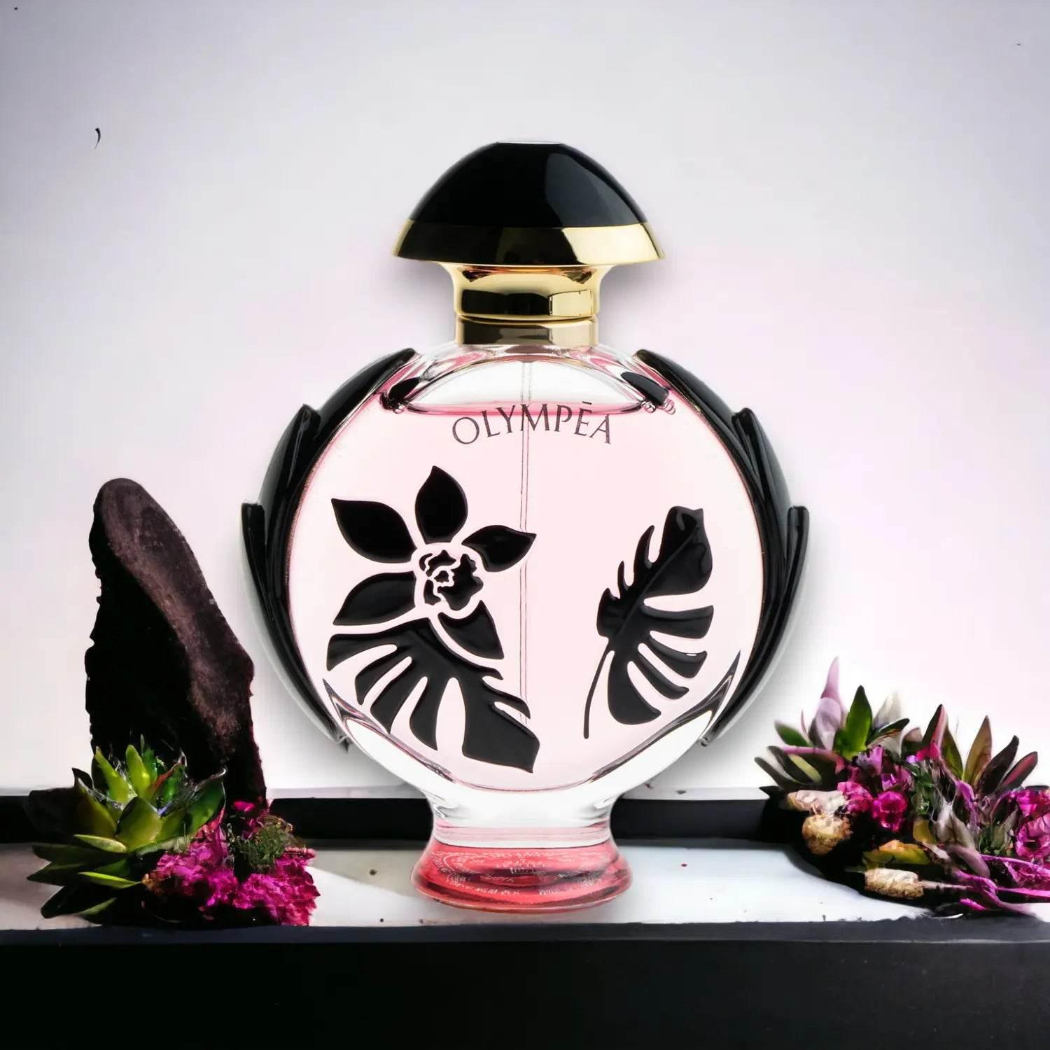 Luxuriöser Parfumflakon mit schwarzem und goldfarbenem Deckel, florale Motive, umgeben von Blumen.