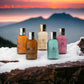 Molton Brown Travel Body Care Collection mit fünf farbigen Duschgels auf verschneitem Baumstamm vor Sonnenuntergang.