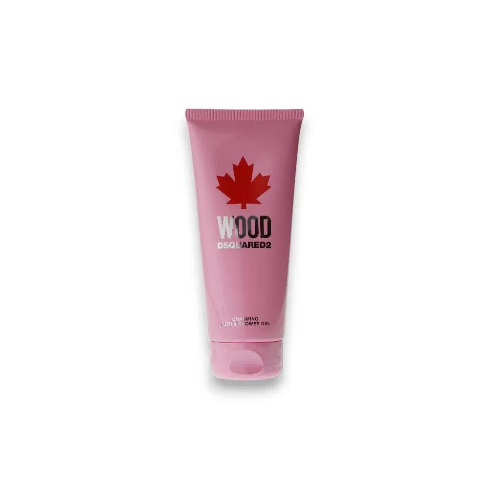 Pinkfarbene Tube Wood Charming Bath & Shower Gel, dekoriert mit rotem Ahornblatt, freigestellt.